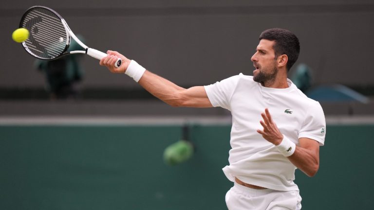 Serbia's Novak Djokovic hits the ball as he warms up on Court One as he practices ahead of his men's singles semifinal match against Italy's Jannik Sinner on day twelve of the Wimbledon tennis championships in London, Friday, July 14, 2023. (AP)