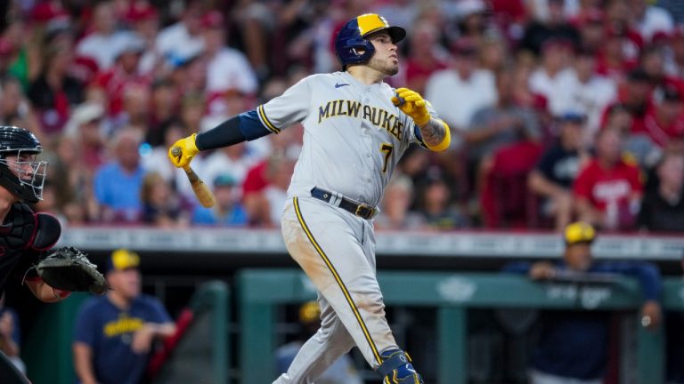 Milwaukee Brewers' Victor Caratini watches his RBI single against the Cincinnati Reds during the seventh inning of a baseball game in Cincinnati, Friday, July 14, 2023. (AP Photo/Aaron Doster)