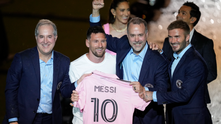 Inter Miami's Lionel Messi, center left, holds his new Inter Miami team jersey as he poses with team co-owners Jorge Mas, left, Jose Mas, second right, and David Beckham during a celebration by the team at DRV PNK Stadium, Sunday, July 16, 2023, in Fort Lauderdale, Fla. It comes one day after Messi, Major League Soccer and Inter Miami finalized his signing through the 2025 season. His first official training session is Tuesday and he is expected to play Friday in a Leagues Cup match against Cruz Azul. (AP)