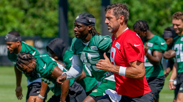 New York Jets quarterback Aaron Rodgers (red jersey) warms up during practice at the NFL football team's training facility, Friday, July 21, 2023, in Florham Park, N.J. (AP)