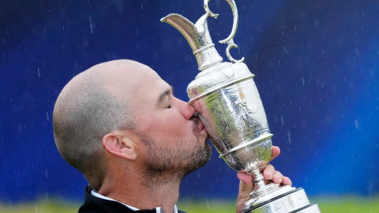 American Brian Harman poses for the media as he holds the Claret Jug trophy for winning the Open Championship at the Royal Liverpool Golf Club in Hoylake, England, Sunday, July 23, 2023. (Jon Super/AP) 