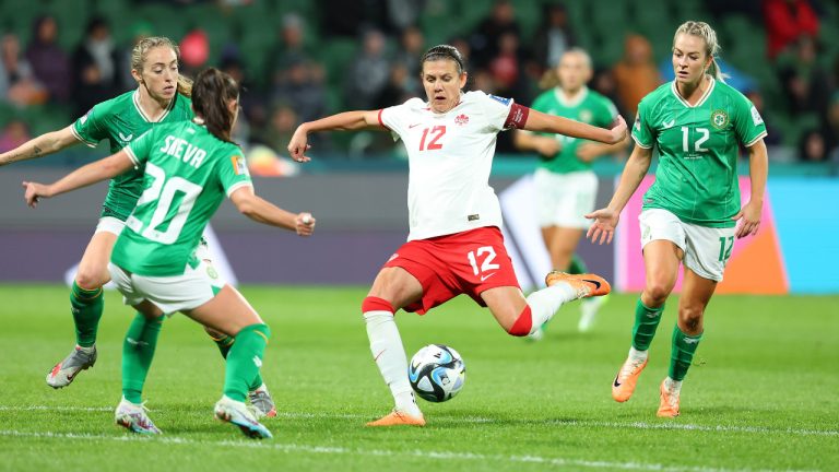 Christine Sinclair of Canada takes a shot at goal as Ireland players Marissa Sheva (20) and Lily Agg (12) defend during during second half action of their Group B match at the FIFA Women's World Cup in Perth, Australia, Wednesday, July 26, 2023. (James Worsfold/CP) 