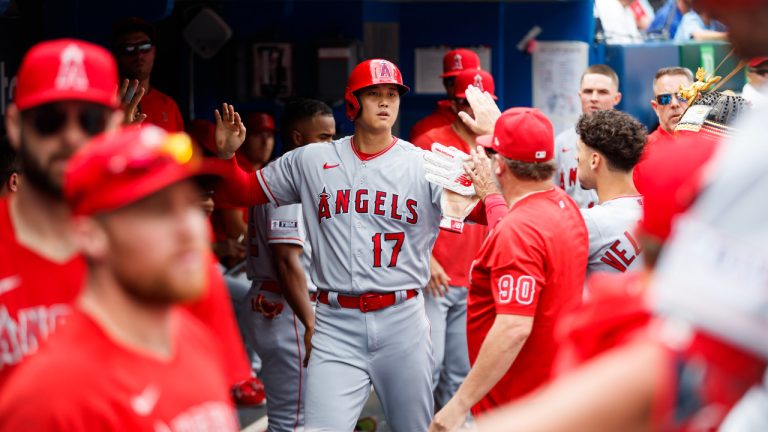 Los Angeles Angels designated hitter Shohei Ohtani (17) celebrates in the dugout after scoring on a sacrifice fly from teammate Hunter Renfroe, not shown, in the third inning of MLB baseball action against the Toronto Blue Jays in Toronto, Sunday July 30, 2023. (Cole Burston/CP) 