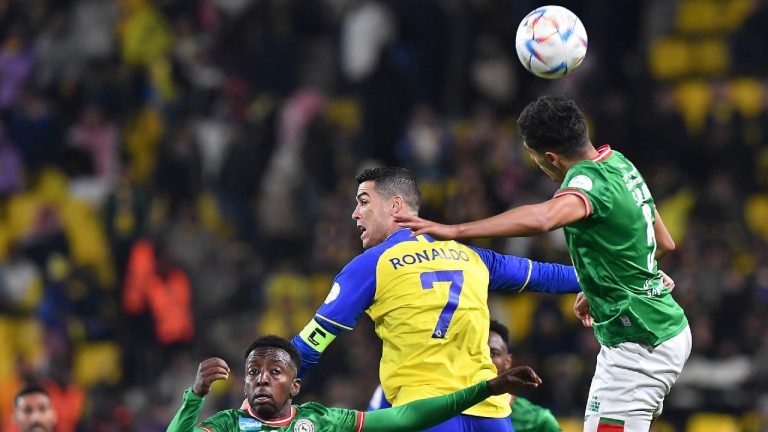 Al Nassr's Cristiano Ronaldo, centre, jumps for the ball against Al Ettifaq's players during the Saudi Pro League match between Al Nassr and Al Ettifaq at Mrsool Park Stadium, in Riyadh, Saudi Arabia, Sunday, Jan. 22, 2023. (AP Photo)