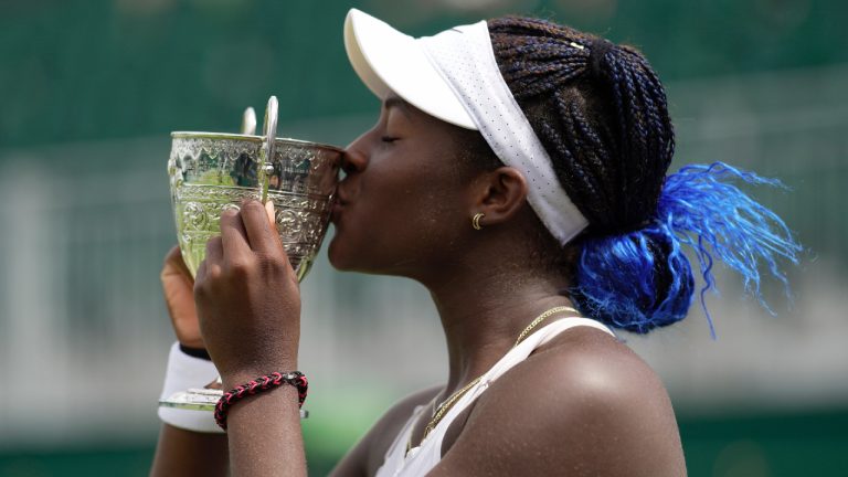 Clervie Ngounoue of the US celebrates with her trophy after beating Nikola Bartunkova of the Czech Republic in the girl's singles final on day fourteen of the Wimbledon tennis championships in London, Sunday, July 16, 2023. (Kin Cheung/AP)