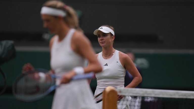 Ukraine's Elina Svitolina, right, and Victoria Azarenka of Belarus walk to their chairs after Svitolina won the women's singles match on day seven of the Wimbledon tennis championships in London, Sunday, July 9, 2023. (Alberto Pezzali/AP)