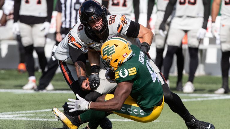 B.C. Lions' Mathieu Betts (90) tackles Edmonton Elks' Kevin Brown (4) during first half CFL action in Edmonton, Alta., on Saturday July 29, 2023. (Jason Franson/CP)