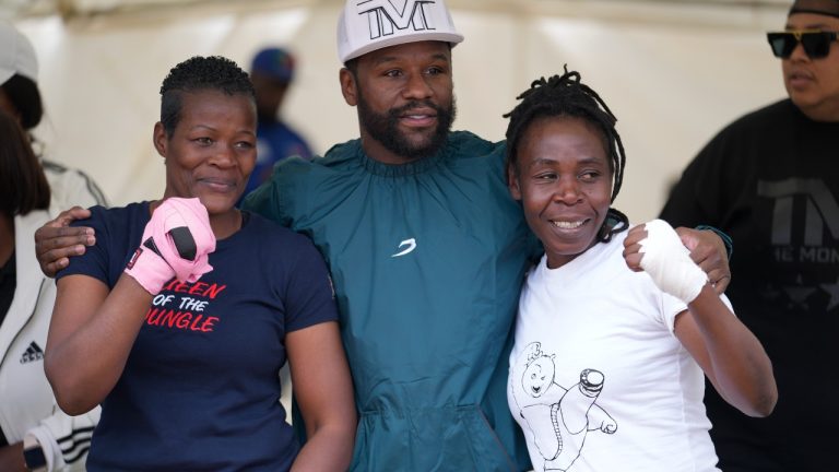 U.S boxing promoter and former professional boxer Floyd Joy Mayweather, center, poses for a picture with women boxers at an event on the outskirts of the capital Harare, Zimbabwe Thursday, July 13, 2023. Mayweather is in the country for what he is calling the Motherland Tour. (Tsvangirayi Mukwazhi/AP)