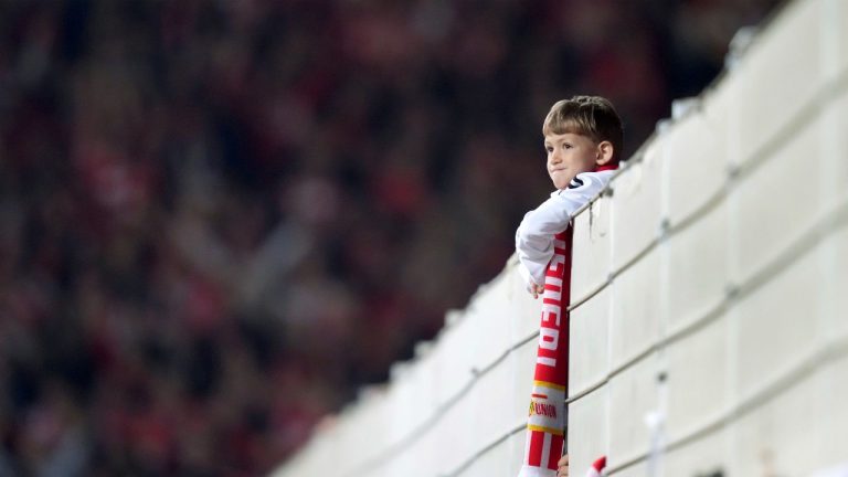 A young Union supporter wears a fan scarf during the German Bundesliga soccer match between 1. FC Union Berlin and Borussia Dortmund in Berlin, Germany, Sunday, Oct. 16, 2022. German soccer’s 50-plus-1 rule designed to prevent the outside takeover of clubs has been given the all-clear and strengthened by the country’s federal competition authority. (AP Photo/Michael Sohn, File)