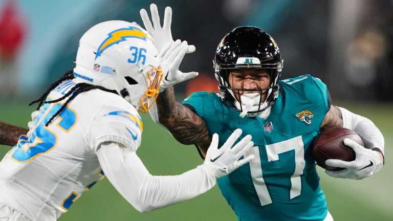 Jacksonville Jaguars tight end Evan Engram (17) runs against Los Angeles Chargers cornerback Ja'Sir Taylor (36) during the second half of an NFL wild-card football game, Saturday, Jan. 14, 2023, in Jacksonville, Fla. (Chris Carlson/AP)