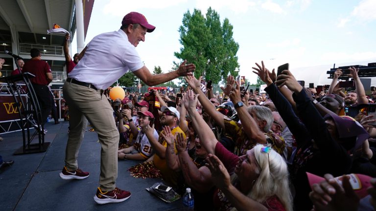 Josh Harris, the leader of a group buying the Washington Commanders, high-fives fans during an NFL football pep rally at FedEx Field in Landover, Md., Friday, July 21, 2023. (Alex Brandon/AP)