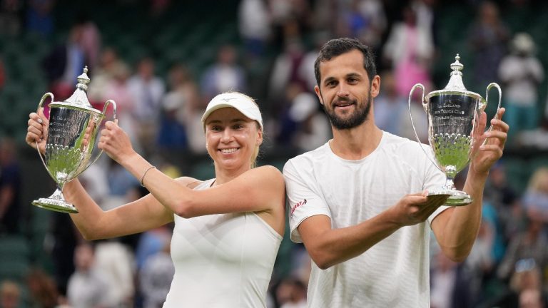 Croatia's Mate Savic, right, and Ukraine's Lyudmyla Kichenok celebrate with their trophies after beating Belgium's Joran Vliegen and China's Xu Yifan to win the final of the mixed doubles on day eleven of the Wimbledon tennis championships in London, Thursday, July 13, 2023. (Alberto Pezzali/AP)