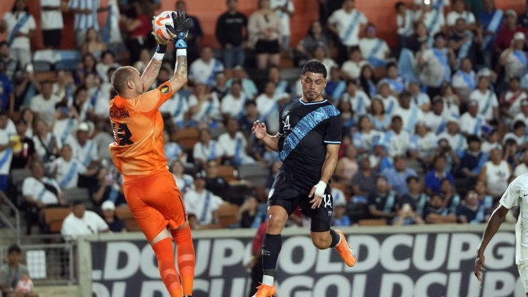 Canada goalkeeper Milan Borjan (18) saves a shot as Guatemala's Darwin Lom (14) leaps in front of him during the first half of a CONCACAF Gold Cup soccer match Saturday, July 1, 2023, in Houston. (David J. Phillip/AP)