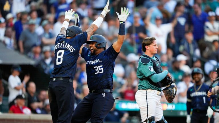 National League's Elias Díaz, of the Colorado Rockies (35), celebrates his two run home run with Nick Castellanos (8), of the Philadelphia Phillies, in the eighth inning during the MLB All-Star baseball game in Seattle, Tuesday, July 11, 2023. (Lindsey Wasson/AP)