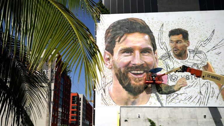 Artist Maximiliano Bagnasco paints a mural of Argentine soccer star Lionel Messi, Monday, July 10, 2023, in the Wynwood neighborhood of Miami. Murals, burgers, beers, and billboards are just a handful of examples that show the euphoria that Messi generates in South Florida and how he will be received when he lands for his new stage as a player with the Major League Soccer team Inter Miami. (Lynne Sladky/AP)