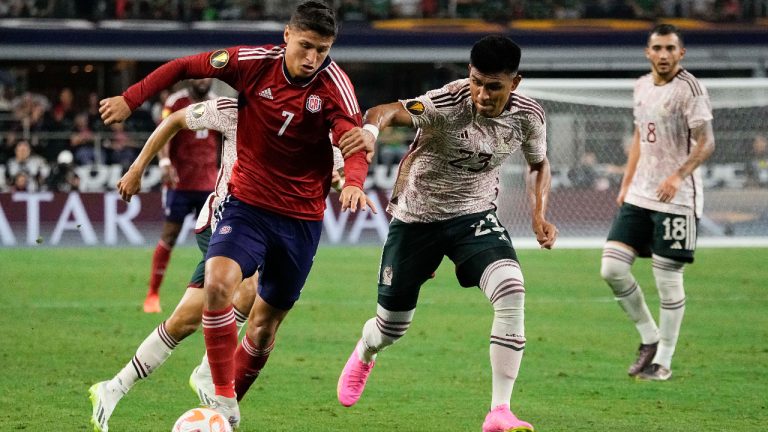 Costa Rica forward Anthony Contreras (7) controls the ball as Mexico defender Jesús Gallardo (23) defends during the first half of a CONCACAF Gold Cup soccer quarterfinal Saturday, July 8, 2023, in Arlington, Texas. (Sam Hodde/AP)