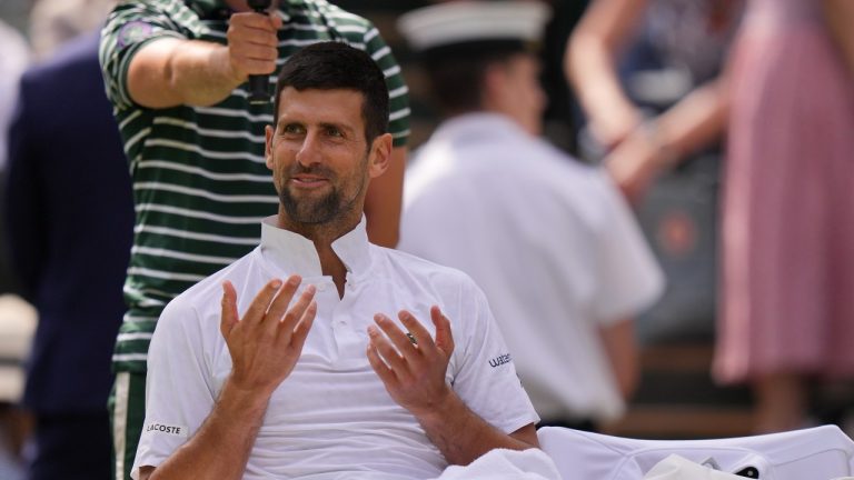 Serbia's Novak Djokovic smiles during a change of ends break Poland's Hubert Hurkacz in a men's singles match on day eight of the Wimbledon tennis championships in London, Monday, July 10, 2023. (Alberto Pezzali/AP)