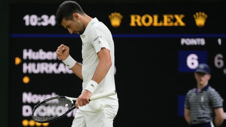 Serbia's Novak Djokovic celebrates after winning the second set against Poland's Hubert Hurkacz in a men's singles match on day seven of the Wimbledon tennis championships in London, Sunday, July 9, 2023. (AP)