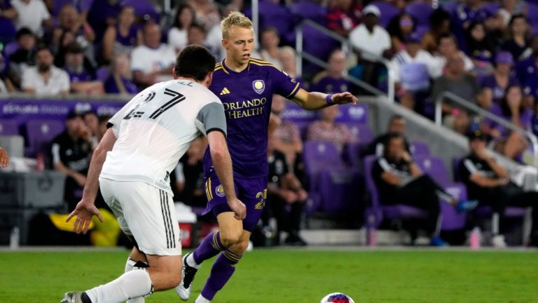 Orlando City's Dagur Thorhallsson, rear, looks for a way around Toronto FC's Shane O'Neill (27) during the second half of an MLS soccer match Tuesday, July 4, 2023, in Orlando, Fla. (John Raoux/AP)