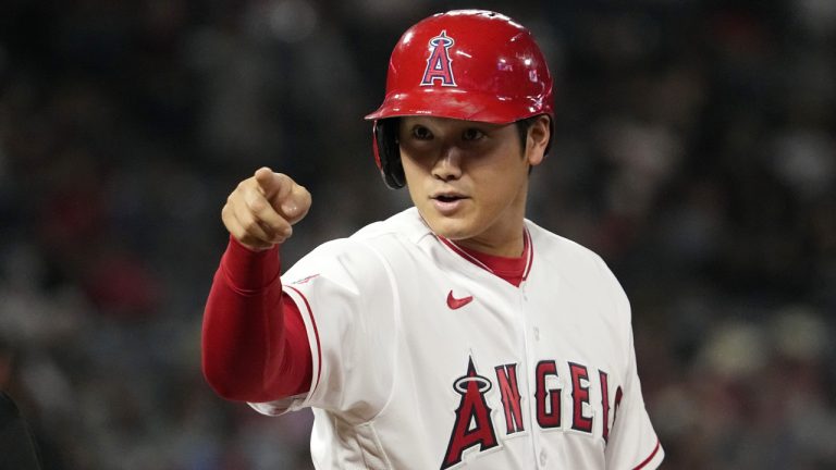 Los Angeles Angels' Shohei Ohtani talks to members of the Chicago White Sox as they sit in their dugout after hitting a single during the eighth inning of a baseball game Wednesday, June 28, 2023, in Anaheim, Calif. (Mark J. Terrill/AP)