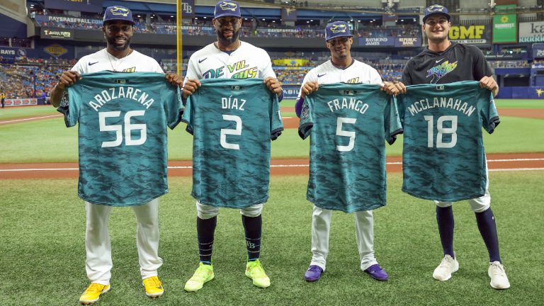 Some of the Tampa Bay Rays representing the team at the All-Star Game, Randy Arozarena, Yandy Diaz, Wander Franco and Shane McClanahan, from left, receive their jerseys prior to the team's baseball game against the Atlanta Braves on Friday, July 7, 2023, in St. Petersburg, Fla. (Mike Carlson/AP)