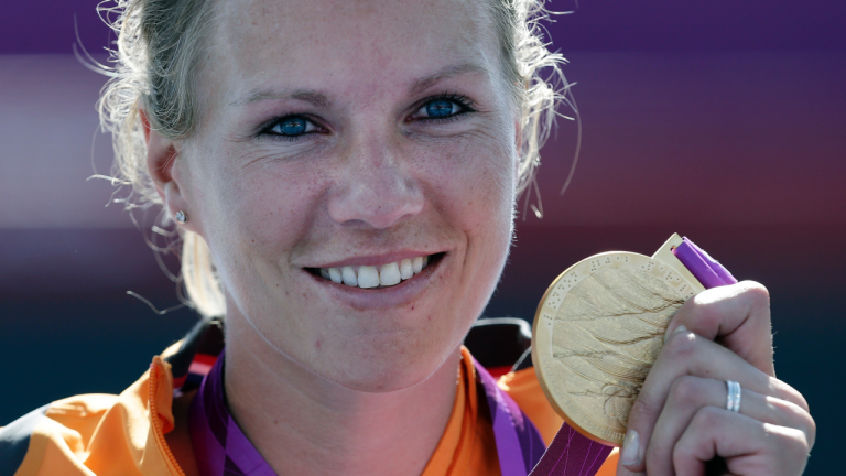 FILE - Esther Vergeer of the Netherlands holds her gold medal for winning the women's wheelchair tennis final at the 2012 Paralympics games, Friday, Sept. 7, 2012, in London. Wheelchair tennis star Esther Vergeer will be inducted into the International Tennis Hall of Fame on Saturday, July 22. (AP Photo/Alastair Grant, File)