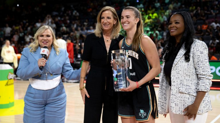 New York Liberty guard Sabrina Ionescu, center right, poses with WNBA Commissioner Cathy Englebert, center left, after winning the WNBA All-Star 3-point contest Friday, July 14, 2023, in Las Vegas. (Ellen Schmidt/Las Vegas Review-Journal via AP)