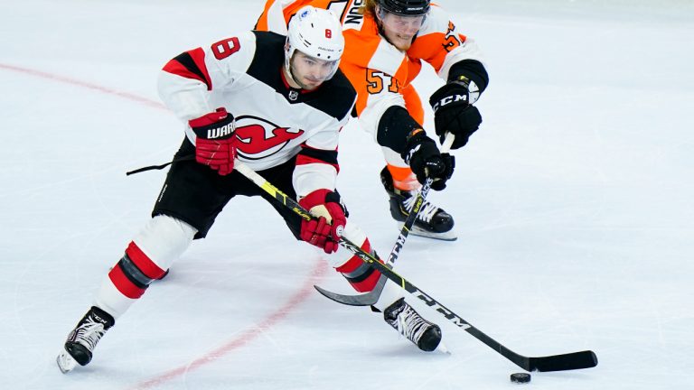 New Jersey Devils' Will Butcher, left, tries to keep the puck away from Philadelphia Flyers' Wade Allison during the third period of an NHL hockey game, Monday, May 10, 2021, in Philadelphia. (Matt Slocum/AP)