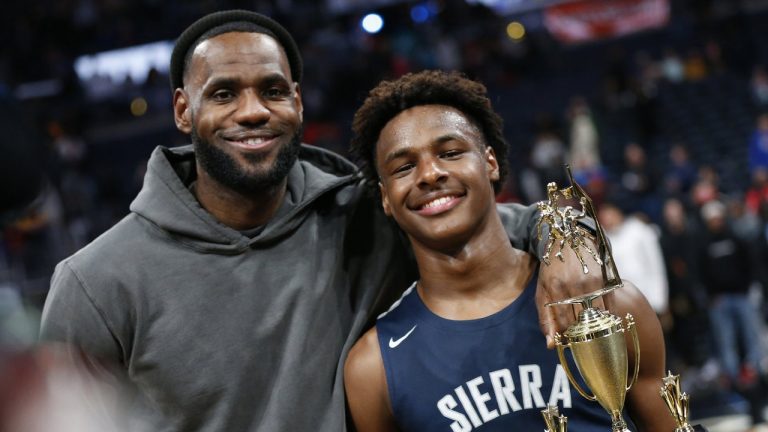 LeBron James, left, poses with his son Bronny after Sierra Canyon beat Akron St. Vincent - St. Mary in a high school basketball game, Saturday, Dec. 14, 2019, in Columbus, Ohio. (Jay LaPrete/AP)