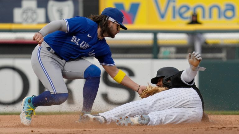 Toronto Blue Jays shortstop Bo Bichette, left, tags out Chicago White Sox's Elvis Andrus at second base on a steal attempt during the sixth inning in the first baseball game of a doubleheader Thursday, July 6, 2023, in Chicago. (Nam Y. Huh/AP)