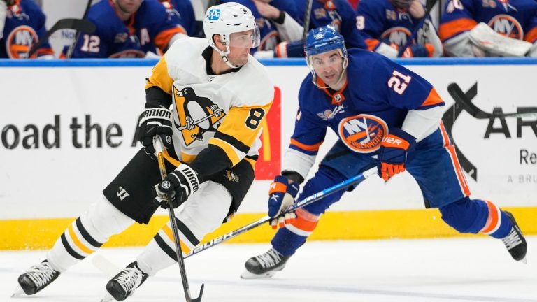 Pittsburgh Penguins defenseman Brian Dumoulin (8) skates against New York Islanders center Kyle Palmieri (21) during the second period of an NHL hockey game Friday, Feb. 17, 2023, in Elmont, N.Y. (Mary Altaffer/AP)