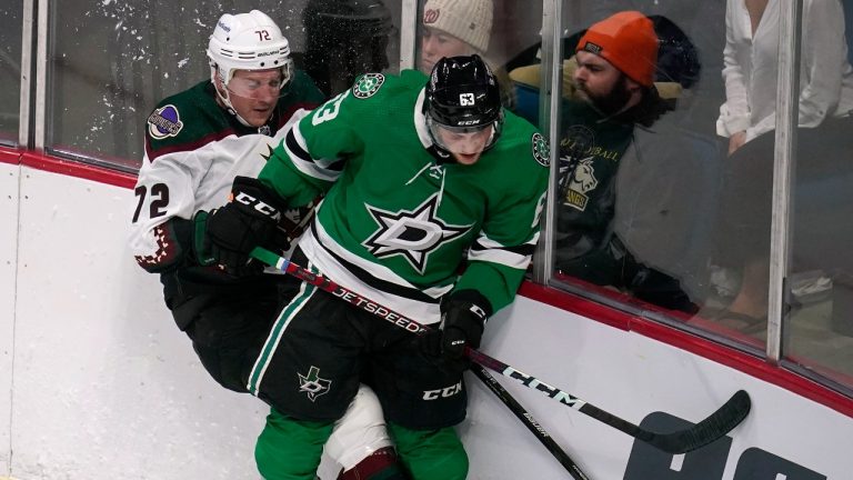 Dallas Stars defenseman Ben Gleason (63) checks Arizona Coyotes center Travis Boyd (72) during the second period of an NHL preseason hockey game Tuesday, Sept. 27, 2022, in Tulsa, Okla. (Sue Ogrocki/AP)