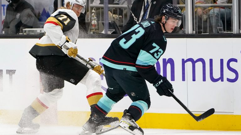 Seattle Kraken's Kole Lind (73) skates ahead of Vegas Golden Knights' William Karlsson during the first period of an NHL hockey game Friday, April 1, 2022, in Seattle. (Elaine Thompson/AP)