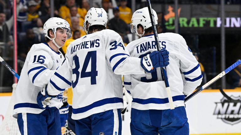 Toronto Maple Leafs center John Tavares (91) celebrates with Mitchell Marner (16) and Auston Matthews (34) after his goal against the Nashville Predators during the first period of an NHL hockey game Sunday, March 26, 2023, in Nashville, Tenn. (Mark Zaleski/AP)