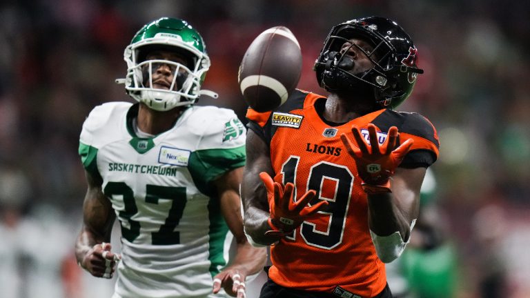 B.C. Lions' Dominique Rhymes (19) has the ball drop between his hands as he fails to make the reception while Saskatchewan Roughriders' Jeremy Clark (37) defends during the second half of CFL football game in Vancouver, on Friday, August 26, 2022. (Darryl Dyck/CP)