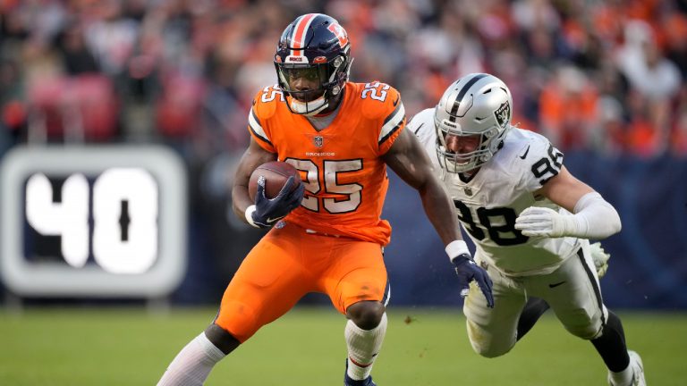 Denver Broncos running back Melvin Gordon III (25) runs against Las Vegas Raiders defensive end Maxx Crosby (98) during the second half of an NFL football game in Denver, Sunday, Nov. 20, 2022. (David Zalubowski/AP)