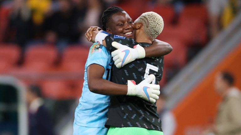 Nigeria's goalkeeper Chiamaka Nnadozie, left, hugs teammate Nigeria's Onome Ebi after defeating Australia at the end of the Women's World Cup Group B soccer match between Australia and Nigeria in Brisbane, Australia, Thursday, July 27, 2023. Nigeria won 3-2. (Aisha Schulz/AP Photo)