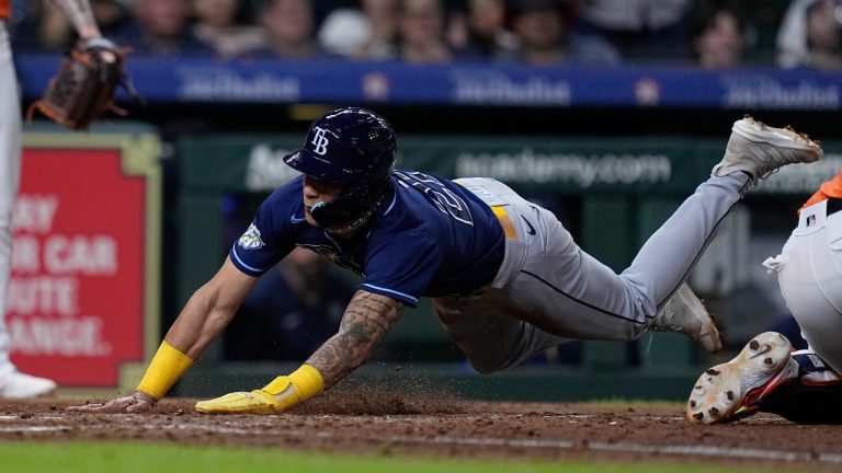 Tampa Bay Rays' Jose Siri scores the go-ahead run on a sacrifice fly hit by designated hitter Yandy Diaz during the ninth inning of a baseball game against the Houston Astros, Friday, July 28, 2023, in Houston. (Kevin M. Cox/AP)