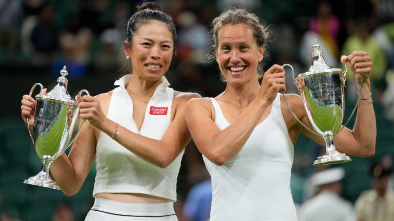 Barbora Strycova of the Czech Republic, right, and Taiwan's Hsieh Su-Wei celebrate with their trophies after beating Australia's Storm Hunter and Belgium's Elise Mertens to win the final of the women's doubles on day fourteen of the Wimbledon tennis championships in London, Sunday, July 16, 2023. (Kirsty Wigglesworth/AP)