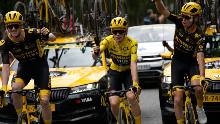 Denmark's Jonas Vingegaard, wearing the overall leader's yellow jersey, toasts champagne with teammates during the twenty-first stage of the Tour de France cycling race over 115 kilometers (71.5 miles) with start in Saint-Quentin-en-Yvelines and finish on the Champs-Elysees in Paris, France, Sunday, July 23, 2023. (Daniel Cole/AP)