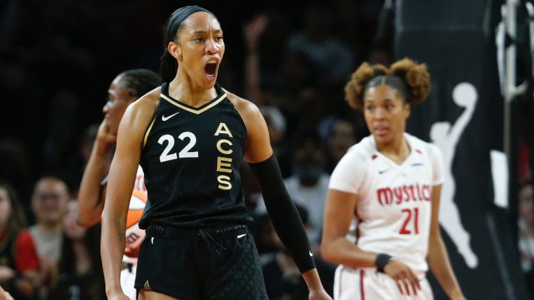 Las Vegas Aces forward A'ja Wilson (22) celebrates after scoring against the Washington Mystics during the first half of a WNBA basketball game Friday, Aug. 11, 2023, in Las Vegas. Mystics forward Tianna Hawkins is at right. (Steve Marcus/Las Vegas Sun via AP)