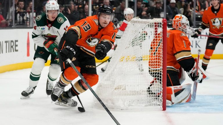 Anaheim Ducks defenseman Simon Benoit (13) controls the puck ahead of Minnesota Wild left wing Matt Boldy (12) during the second period of an NHL hockey game in Anaheim, Calif., Wednesday, Dec. 21, 2022. (Ashley Landis/AP)