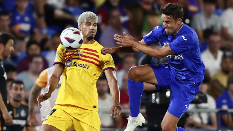 Barcelona's Ronald Araujo, left, and Getafe's Juanmi Latasa challenge for the ball during the Spanish La Liga soccer match between Getafe and FC Barcelona at the Coliseum Alfonso Perez stadium in Getafe, Spain, Sunday, Aug. 13, 2023. (Alvaro Medranda/AP)