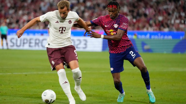 Leipzig's Mohamed Simakan, right, challenges Bayern's Harry Kane during the German Super Cup final between FC Bayern Munich and RB Leipzig at the Allianz Arena stadium in Munich, Germany, Saturday, Aug. 12, 2023. (Matthias Schrader/AP)