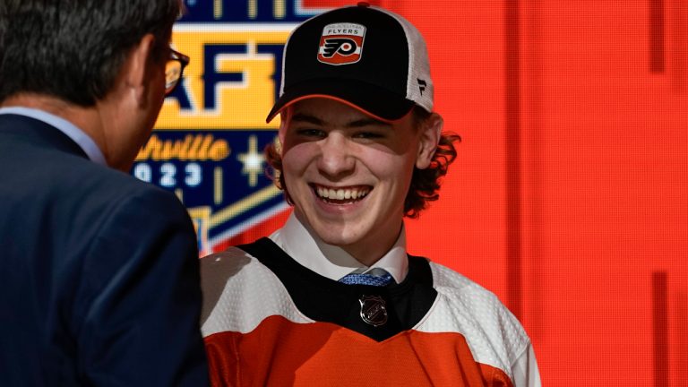 Oliver Bonk smiles on stage after being picked by the Philadelphia Flyers during the first round of the NHL hockey draft Wednesday, June 28, 2023, in Nashville, Tenn. (George Walker IV/AP)