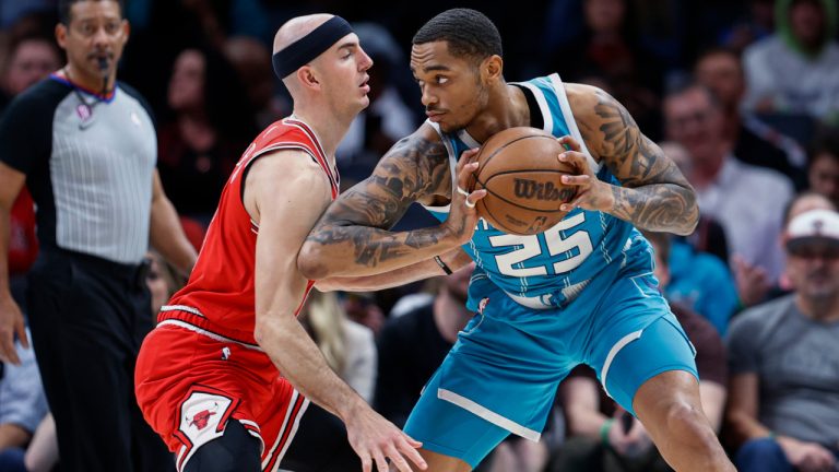 Charlotte Hornets forward P.J. Washington (25) looks to drive against Chicago Bulls guard Alex Caruso during the first half of an NBA basketball game in Charlotte, N.C., Friday, March 31, 2023. (Nell Redmond/AP) 