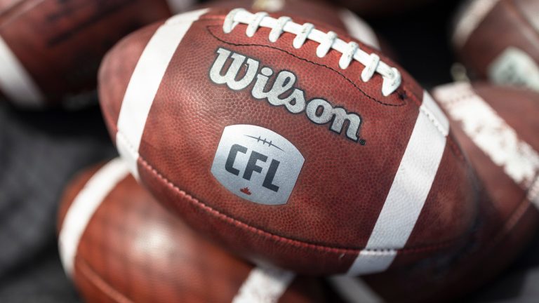 CFL logo seen on a football during the opening day of CFL training camp on May 14, 2023. (Nick Iwanyshyn/CP)