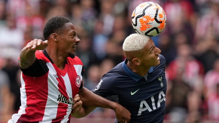 Brentford's Ethan Pinnock, left, challenges for the ball with Tottenham's Richarlison during an English Premier League soccer match between Brentford and Tottenham Hotspur at the Community Stadium in London, Sunday, Aug. 13, 2023. (Frank Augstein/AP) 