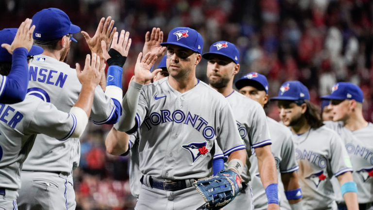 Toronto Blue Jays' Whit Merrifield, center, celebrates with teammates after their 4-3 victory against the Cincinnati Reds in a baseball game, Saturday, Aug. 19, 2023, in Cincinnati. (AP)