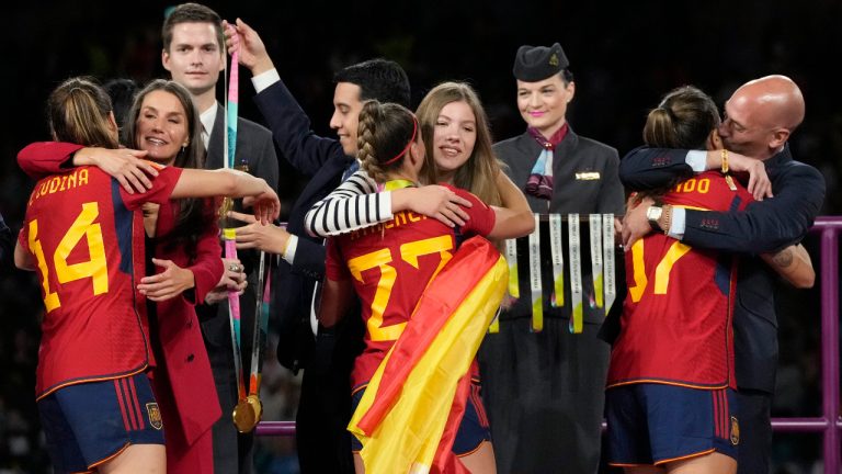 President of Spain's soccer federation, Luis Rubiales, right, embraces Alba Redondo as Queen Letizia of Spain, second left, congratulates Laia Codina, and Princess Infanta Sofia embraces Athenea Del Castillo during the awards ceremony for the Women's World Cup soccer final at Stadium Australia in Sydney, Australia, Sunday, Aug. 20, 2023. (AP)